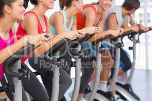 Fit people working out at spinning class