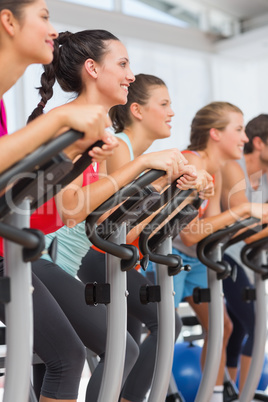 Fit people working out at spinning class