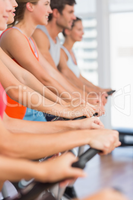 Fit people working out at spinning class