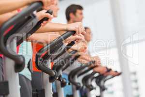 Fit people working out at spinning class