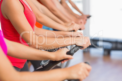 Fit people working out at spinning class