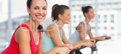 Fit people working out at spinning class