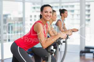 Fit people working out at spinning class