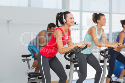 Fit people working out at spinning class