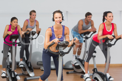 Fit people working out at spinning class