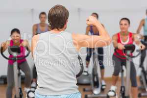 Trainer and fitness class at spinning class