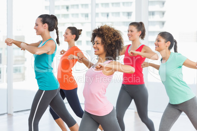 Fitness class and instructor doing pilates exercise