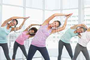 Smiling women doing pilate exercises in fitness studio