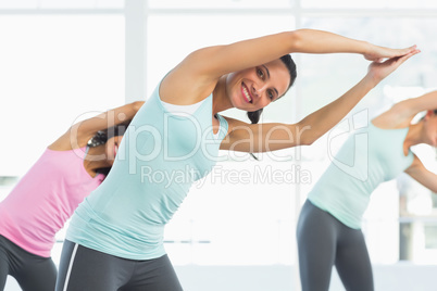Smiling women doing pilate exercises