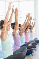 Sporty young women in meditation pose with eyes closed