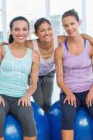 Fit young women smiling in exercise room
