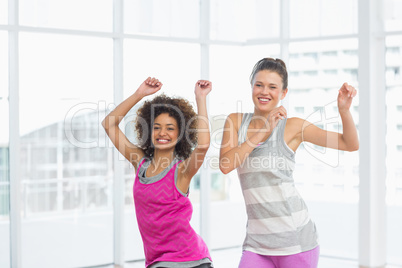 Cheerful fit women doing pilates exercise