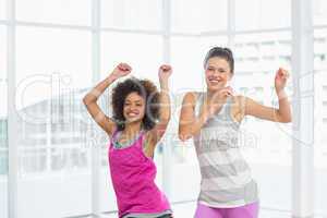 Cheerful fit women doing pilates exercise