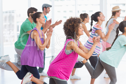 Fitness class and instructor doing pilates exercise