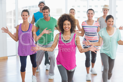 Fitness class and instructor doing pilates exercise