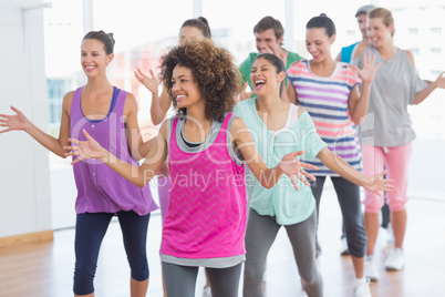 Fitness class and instructor doing pilates exercise