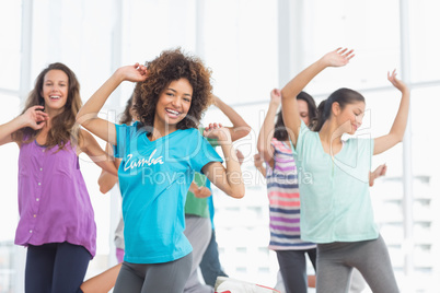 Fitness class and instructor doing pilates exercise