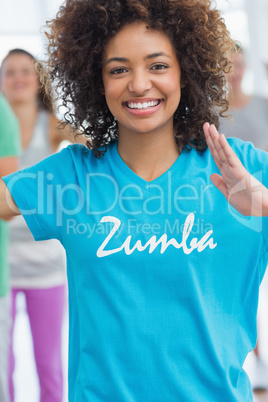 Cheerful female instructor doing pilates exercise