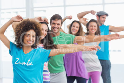 Fitness class and instructor doing pilates exercise