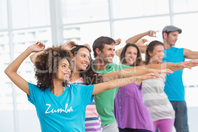 Fitness class and instructor doing pilates exercise