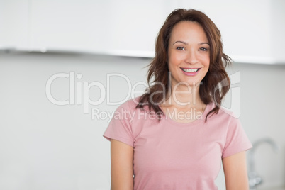 Portrait of a smiling casual woman in kitchen