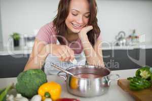 Smiling woman preparing food in kitchen