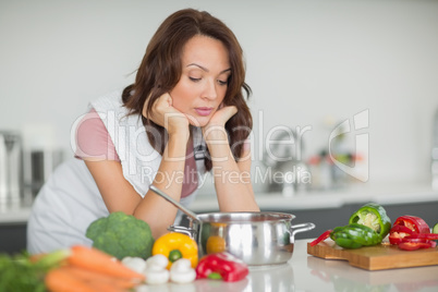 Serious woman preparing food in kitchen