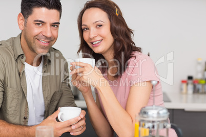 Portrait of a happy loving couple with coffee cup