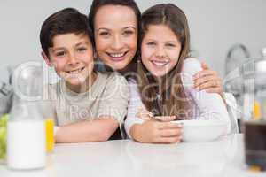 Closeup of a smiling mother with young in kitchen