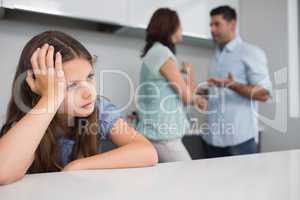 Closeup of a sad girl while parents quarreling
