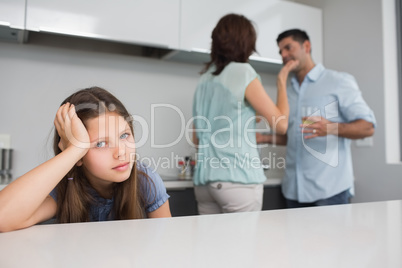 Closeup portrait of a sad girl while parents quarreling