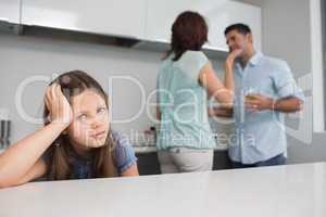 Closeup portrait of a sad girl while parents quarreling