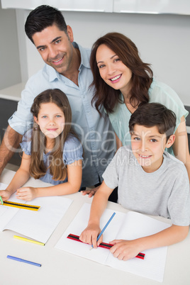 Portrait of a happy family of four in kitchen