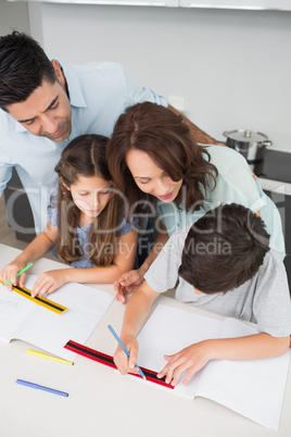 Couple helping kids with their homework