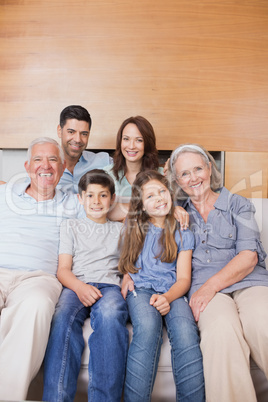 Extended family sitting on sofa in the living room