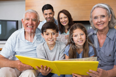 Portrait of an extended family looking at their album photo