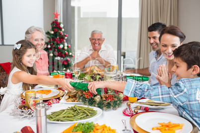 Cheerful family at dining table for christmas dinner