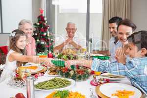Cheerful family at dining table for christmas dinner