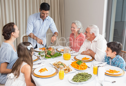 Extended family at dining table in house
