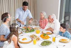 Extended family at dining table in house