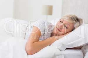 Woman sleeping with eyes closed in bed