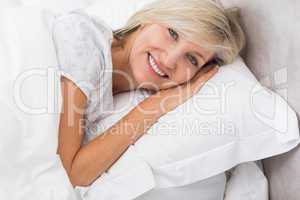 Portrait of a mature woman resting in bed