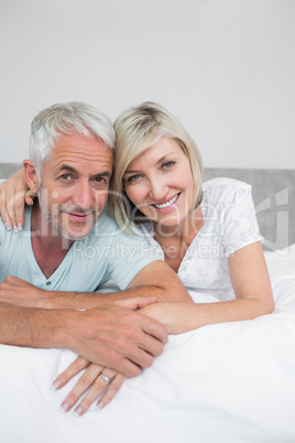 Portrait of a mature couple lying in bed