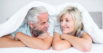 Closeup of a mature couple lying in bed