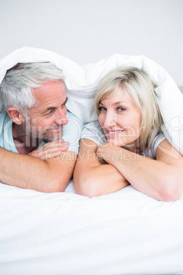 Closeup of a mature couple lying in bed