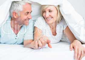 Closeup of a mature couple lying in bed