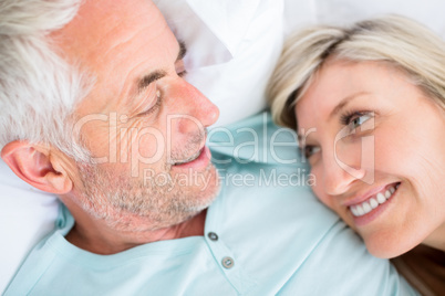 Closeup of a mature couple lying in bed