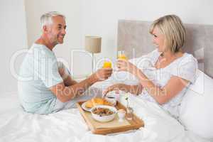 Mature couple having breakfast in bed