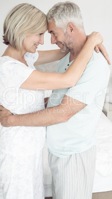 Loving mature couple with arms around