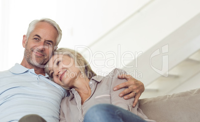 Relaxed mature couple sitting on sofa